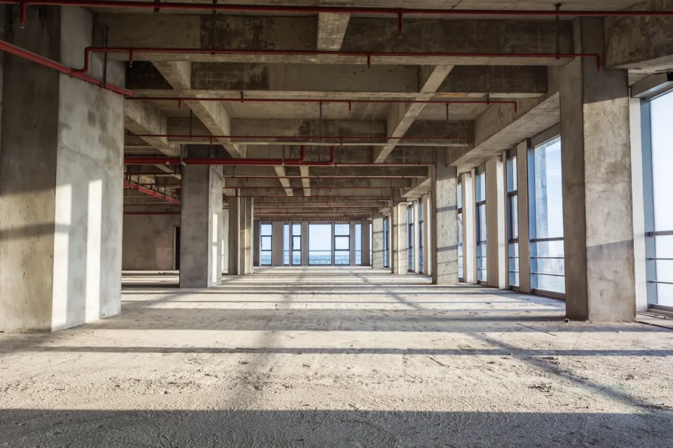Interior of vacant/unfinished concrete open plan office building.